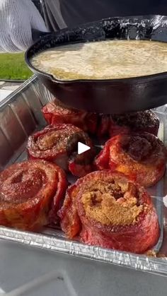 some food is sitting in a pan on the table and someone is holding it up