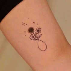 a woman's thigh with a flower tattoo on it