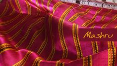 the fabric is pink and yellow with stripes on it, as well as a name that says mashru