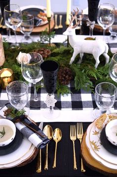 a black and white table setting with deer figurines