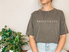 This simple and casual bridesmaid inspired t-shirt is the perfect bridal party gift.  Can even match outfits with the bride tribe on the bachelorette party by selecting the simple bride tee shirt. Give the gift of comfort, style and ease to the wonderful bridesmaids that are a big part of the wedding. *Black text is only available with the color shirt White, if selected.  Comfort Colors introduces its garment-dyed t-shirt. The soft-washed, garment-dyed fabric brings extra coziness to your wardro Bride And Bridesmaid Shirts Wedding Day, Cotton Crew Neck T-shirt For Hen Party, Short Sleeve Tops For Bridesmaids, Relaxed Fit Crew Neck Top For Wedding, Custom Text Short Sleeve Tops For Wedding, Bride Tee Shirts, Bride And Bridesmaid Shirts, Casual Bridesmaid, Bridesmaid Tshirts