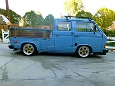 an old blue truck parked in a driveway