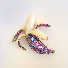 a peeled banana with colorful sprinkles on it