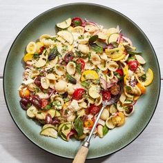 a white plate topped with scallops covered in tomatoes and other veggies