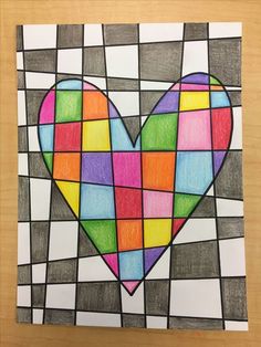 a heart made out of colored squares on a piece of paper with the word love written in it