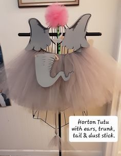 an elephant tutu with ears trunk tail and dust stuck in the skirt is on display