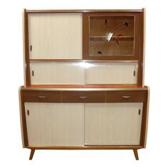 a wooden cabinet with two doors and drawers