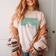 Part of our 'Boy Meets World' tribute collection, our comfy 'Mr. Feeny' tee depicts the brilliant teacher every 90's kid grew up learning from, sitting at his desk before a chalkboard of some of his most famous lines. Featuring our minimalist line-style sketch art w/ a big pop of old school chalkboard green, our 'Mr. Feeny' tee is for everyone who loves this iconic TV teacher and the amazing show he was on!  DESIGN DEPICTS: Mr. Feeny at his desk, in front of a chalkboard full of things he famously said. MORE COLORS: https://www.etsy.com/listing/1314948763/bmw-mr-feeny-crewneck-tee-unisex-fit-90s?click_key=3dc6d6aa0ee2ff5f2983bcccbb2ebab00179c73b%3A1314948763&click_sum=14453ccc&ga_search_query=feeny&ref=shop_items_search_3&crt=1&sts=1 DETAILS: * 100% combed and ring-spun cotton (Heather col School T-shirt With Graphic Print And Relaxed Fit, Relaxed Fit School T-shirt With Screen Print, Relaxed Fit Screen Print T-shirt For School, Relaxed Fit Graphic Print T-shirt For School, Relaxed Fit Graphic T-shirt For School, Retro Relaxed Fit Tops For School, Relaxed Fit Graphic Tee For School, Retro Crew Neck Top In Ring-spun Cotton, Unisex Graphic Print Tops For School