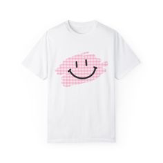 Comfort Colors Smiley Face Plaid T-Shirt | Cute and Cozy Design Stay comfy and cute with this fun Comfort Colors 1717 t-shirt featuring an adorable smiley face peeking out from a trendy plaid design! Crafted from ultra-soft, vintage-washed cotton, this tee is perfect for anyone who loves laid-back style with a playful twist. The unique blend of classic plaid and a happy, smiling face brings a little extra joy to your everyday wardrobe. Features: -Comfort Colors 1717 Tee: Made from 100% ring-spun cotton for that lived-in softness from day one. -Playful Design: The cute smiley face peeking out from a plaid pattern adds charm and personality to your outfit. -Relaxed Fit: Ideal for casual, everyday wear with its relaxed and comfortable silhouette. -Versatile Style: Dress it up with your favori Playful White T-shirt With Smiley Face, Casual Plaid Cotton T-shirt, Cute Plaid Short Sleeve Tops, Cute Short Sleeve Plaid Tops, Cute Pink Smiley Face Top, Fun Cotton T-shirt With Smiley Face, Cute Cotton Tops With Smiley Face, Cute White T-shirt With Smiley Face, Playful White Top With Smiley Face