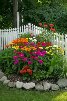 a white picket fence with flowers in the foreground