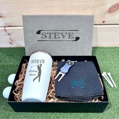 a golf gift set in a box on the grass