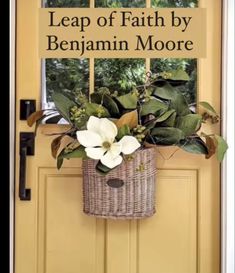 a door with a basket full of flowers and the words leap of faith by benjamin moore