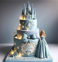 a blue birthday cake with a princess figure on top