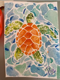 a watercolor drawing of a sea turtle with blue, green and orange colors on it's shell