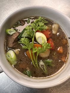 a white bowl filled with soup and vegetables