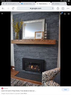 a fire place with a mirror above it