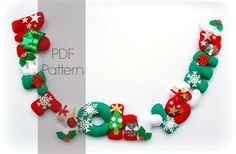 a christmas wreath made out of felt on a white surface with red and green decorations