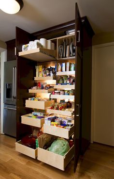 an organized pantry in the corner of a room