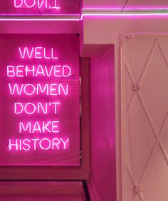 a pink neon sign that says well behaved women don't make history