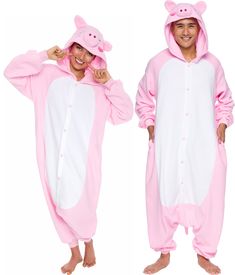 man and woman in pink pig onesuits standing next to each other wearing matching pajamas