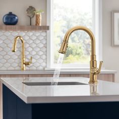 a faucet with water running from it's spout in a kitchen