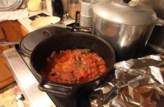 a pot filled with food sitting on top of a stove