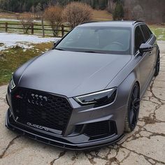 a grey car parked in front of a snow covered field