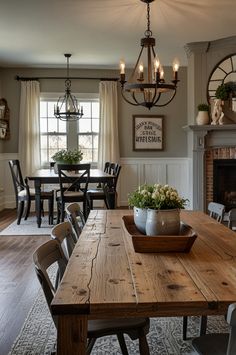 a dining room table with chairs and a potted plant on top of it in front of a fireplace