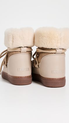 Find INUIKII Classic High Sneaker Boots on Editorialist. Dyed sheep shearling, from China. Leather: Sheepskin. Suede upper with grained leather trim. Pull-on silhouette with adjustable laces. Rubber sole. Made in Portugal. This item cannot be gift-boxed. Shearling Boots, Sheepskin Boots, High Sneakers, Leather High Tops, Brown Ankle Boots, Sand Beige, Classic Sneakers, Designer Boots, Classic Leather