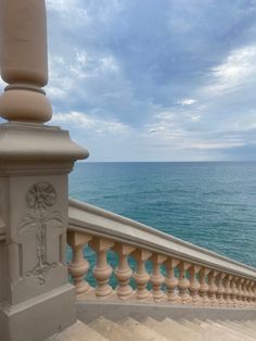 a balcony overlooking the ocean on a cloudy day