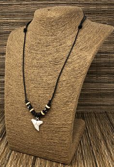 "Shark teeth necklace Adjustable Shark Tooth Unisex Necklace Handmade Necklace. Adjustable cord with sliding knots from 15\" Inches up to 30 Inches Around the Neck. Adjustable Cord - Fits Most Size. Use this necklace short or long. Pull the knots to adjust the length. This beautiful necklace is simply stunning. Our commitment to excellent quality ensures each piece is skillfully inspected.Order this today or browse our incredible selection of jewelry. FAST SHIPPING! To visit my Etsy Shop: https: Adjustable Casual Pendant Necklace, Casual Adjustable Pendant Necklace, Casual Adjustable Nickel Free Necklace, Casual Black Pendant Jewelry, Black Jewelry With Adjustable Chain For Beach, Nickel-free Adjustable Casual Necklace, Black Casual Necklace With Adjustable Cord, Casual Black Necklace With Adjustable Cord, Shark Tooth Necklace Aesthetic