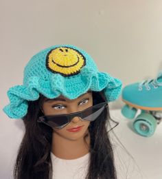 This is a Spring Collection Bucket Hat with a Smiley Face design and a Ruffle Brim. ⭐️ One size fits most; Stretchy⭐️ ⭐️Made to order⭐️ ⭐️Made with 100% Acrylic yarn⭐️ ⭐️ Machine wash warm, Tumble dry low⭐️ ⭐️Do NOT bleach, Iron, or Dry clean⭐️ ⭐️Ruffles can be altered⭐️ Trendy Adjustable Mini Hats For Winter, Cute Adjustable Winter Bucket Hat, Blue Bucket Hat One Size, Trendy One Size Festival Hat, Trendy One-size Festival Hats, Trendy Festival Hats, Trendy Crochet Cap Hat, Fun Winter Bucket Hat With Adjustable Fit, Playful Adjustable Mini Bucket Hat