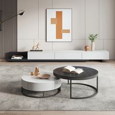 a modern living room with two tables and a book shelf on the wall behind it