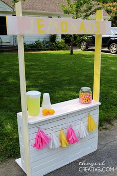 an ice cream stand with lemonade and candy on it