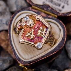 This antique JR Wood Creature Ring from the 1930s features great reddish purple to orange and blue patina with a wrap around creature that is accented with diamonds. The ring is crafted in 10k yellow gold and is currently a size 9.25. The ring has been sized before leaving the shank a bit rough, this will be fixed during the complimentary sizing or upon request. One of the diamonds is chipped. Unique Collectible Diamond Rings, Vintage Engraved Ruby Ring, Vintage Diamond Ruby Ring For Collectors, Vintage Ruby Ring With Diamond For Collectors, Heirloom Collectible 14k Stamped Ruby Ring, Unique Yellow Gold Signet Ring Collectible, Unique Yellow Gold Signet Ring For Collectors, Reddish Purple, Brand Presentation