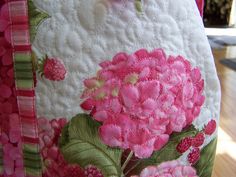 a pink flowered purse is sitting on a table