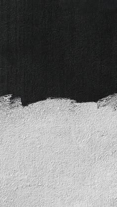 a black and white wall with some paint on it