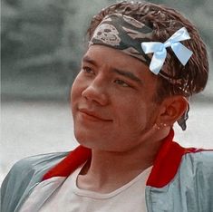 a young man with a bandana on his head