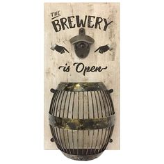 a sign that says the brewery is open with a birdcage hanging from it