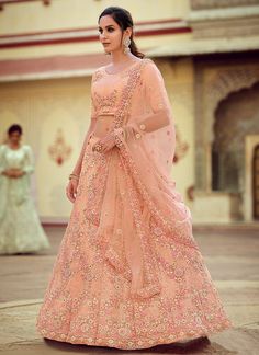 Peach Sequence And Dori Embellished Lehenga Choli Set will make you look more beautiful on this wedding season with indian ethnic essence. This set comprises of zari, resham dori and sequence embroidery work on soft net choli paired with all over equally embellished soft net lehenga with santoon lining. The beauty part is it’s border and butti embroidered soft net dupatta. Style this set with heels and golden jewellery to look stunning with all bridal drama. This set comprises of a designer chol Luxury Peach Dupatta For Party, Luxury Peach Lehenga For Reception, Luxury Peach Georgette Dupatta, Luxury Traditional Peach Lehenga, Luxury Peach Lehenga With Pallu, Luxury Semi-stitched Peach Dupatta, Wedding Reception Program, Peach Lehenga, Net Blouse