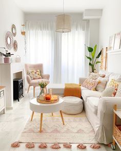 a living room filled with lots of furniture and decor on top of a white floor