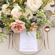 an image of a table setting with flowers and place settings on the menu card area