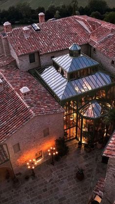 an aerial view of a building with lights on it's roof and surrounding courtyard