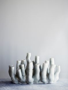 a group of white vases sitting on top of a table