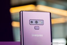 a purple samsung phone sitting on top of a table