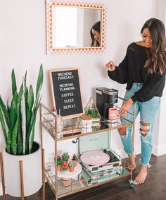 a woman standing in front of a mirror with an instagram