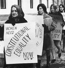 black and white photograph of women holding protest signs