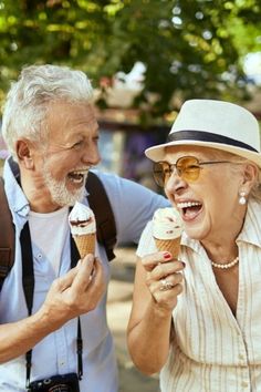 an older man and woman eating ice cream