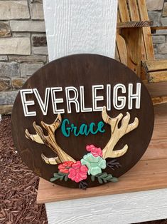 a wooden sign that says, everlight grace with antlers and flowers on it