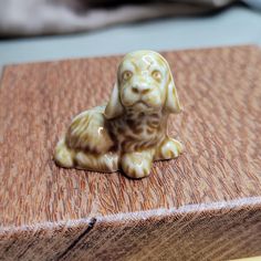 a small dog figurine sitting on top of a wooden box